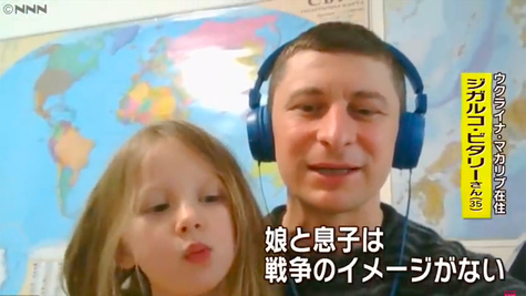 Vitaly, who lives in Makharyb, Ukraine, is interviewed while holding his daughter in front of him. The subtitles read, 